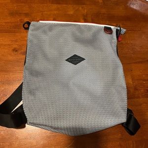 Black and white net material backpack